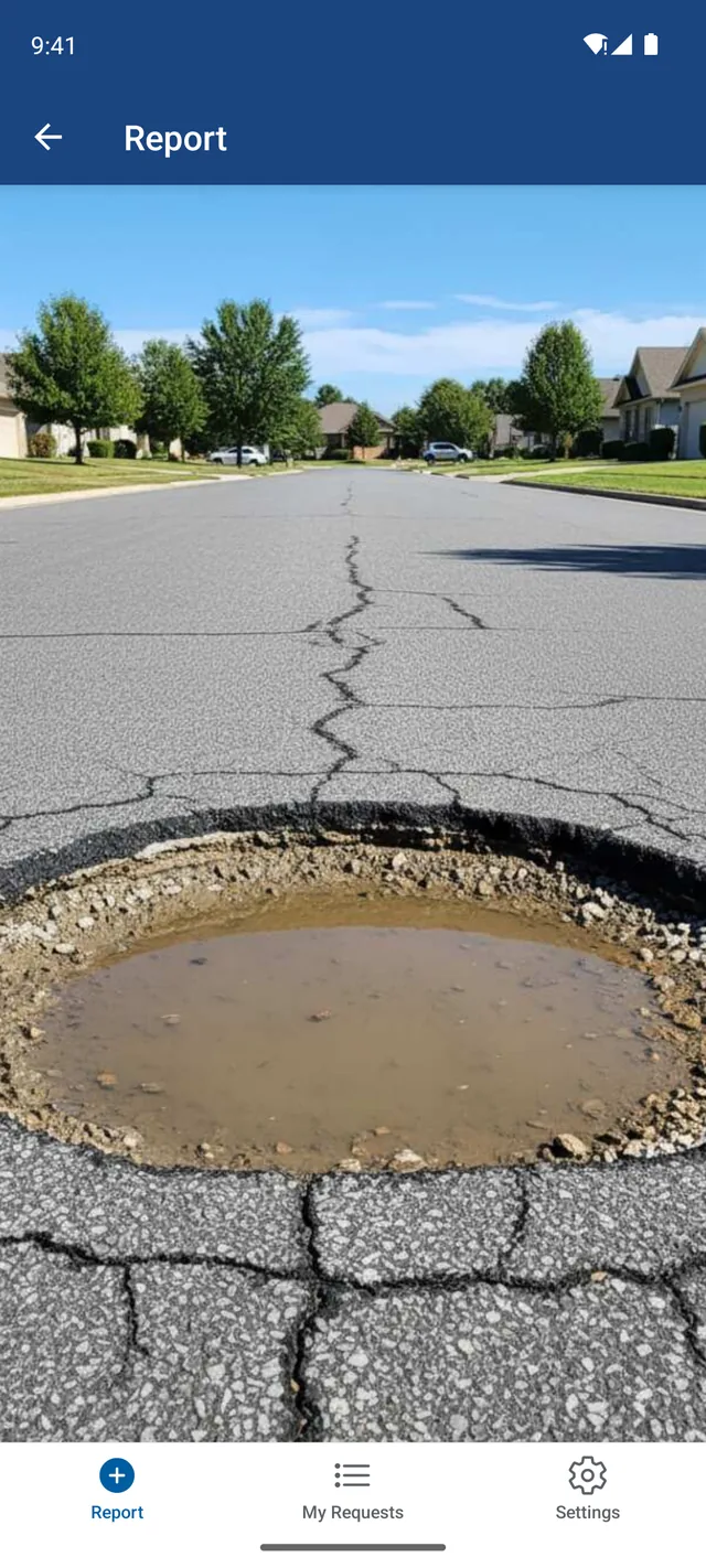 The app open on a phone, showing a photograph of a flooded pothole in a residential street.